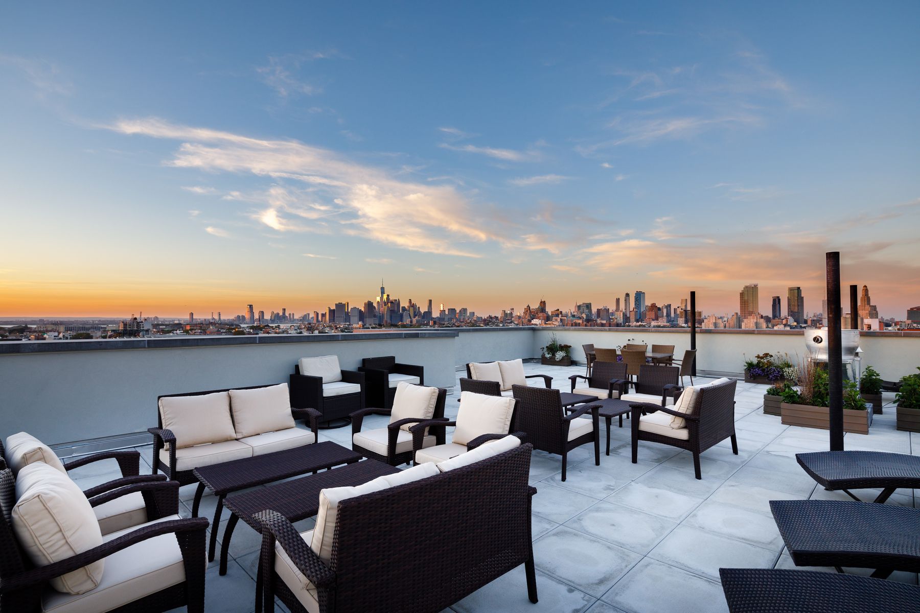 Rooftop deck with ample seating and lounge chairs with city views
